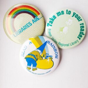 A photograph of 3 SRC buttons that Erin Crowley received as a child. 